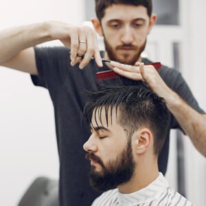 Home stylish man sitting in a barbershop